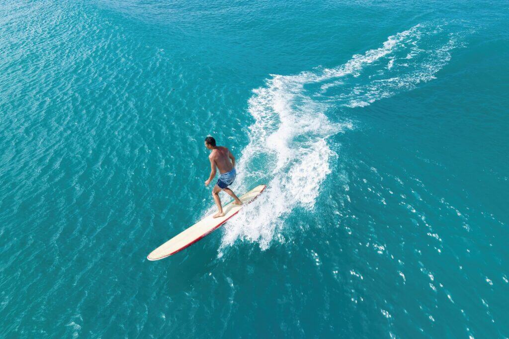 Surfing in Big Island Hawaii with ocean views and tropical lifestyle.