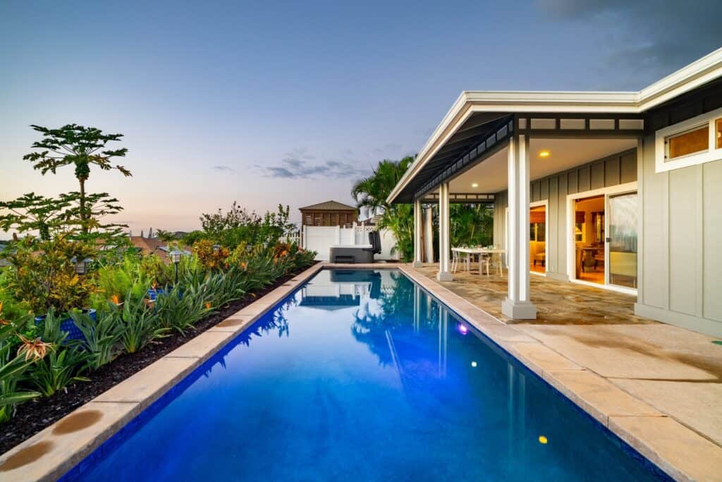 Modern Kona estate with ocean views, outdoor living, and tropical landscaping.