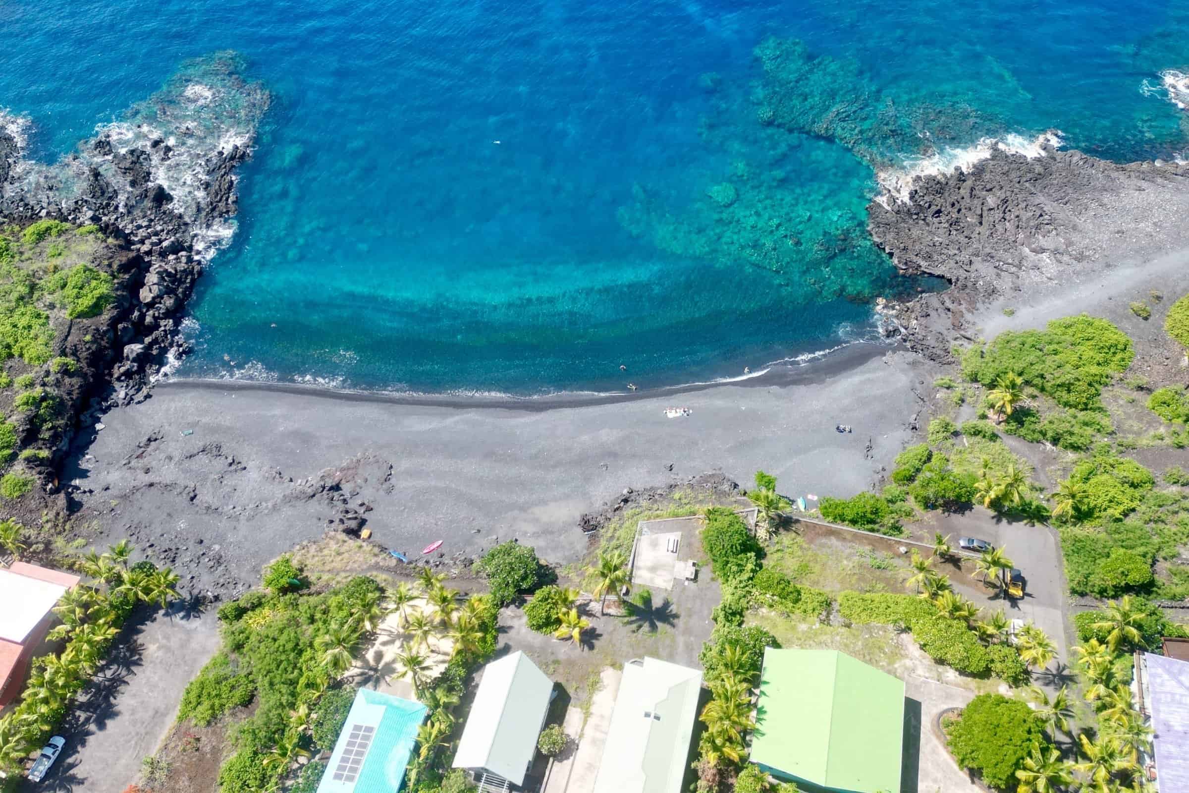 Aerial view of Big Island Hawaii coastline showcasing volcanic shoreline and lush tropical landscape.