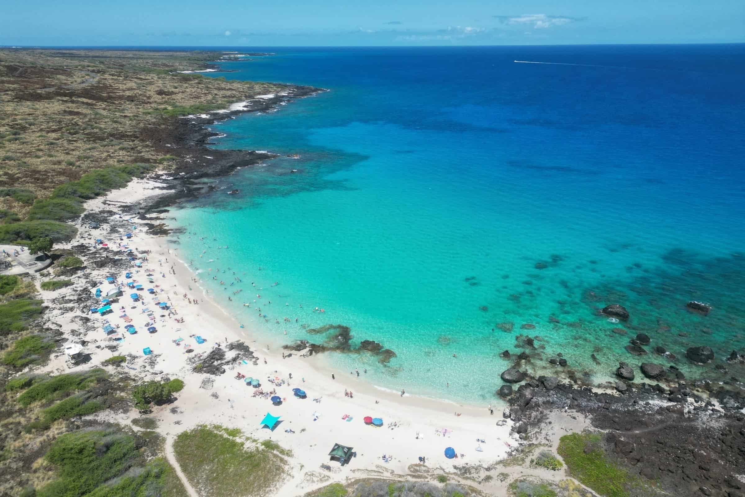 Kua Bay on the North Kona coast, white sand and clear water backed by lava rock.