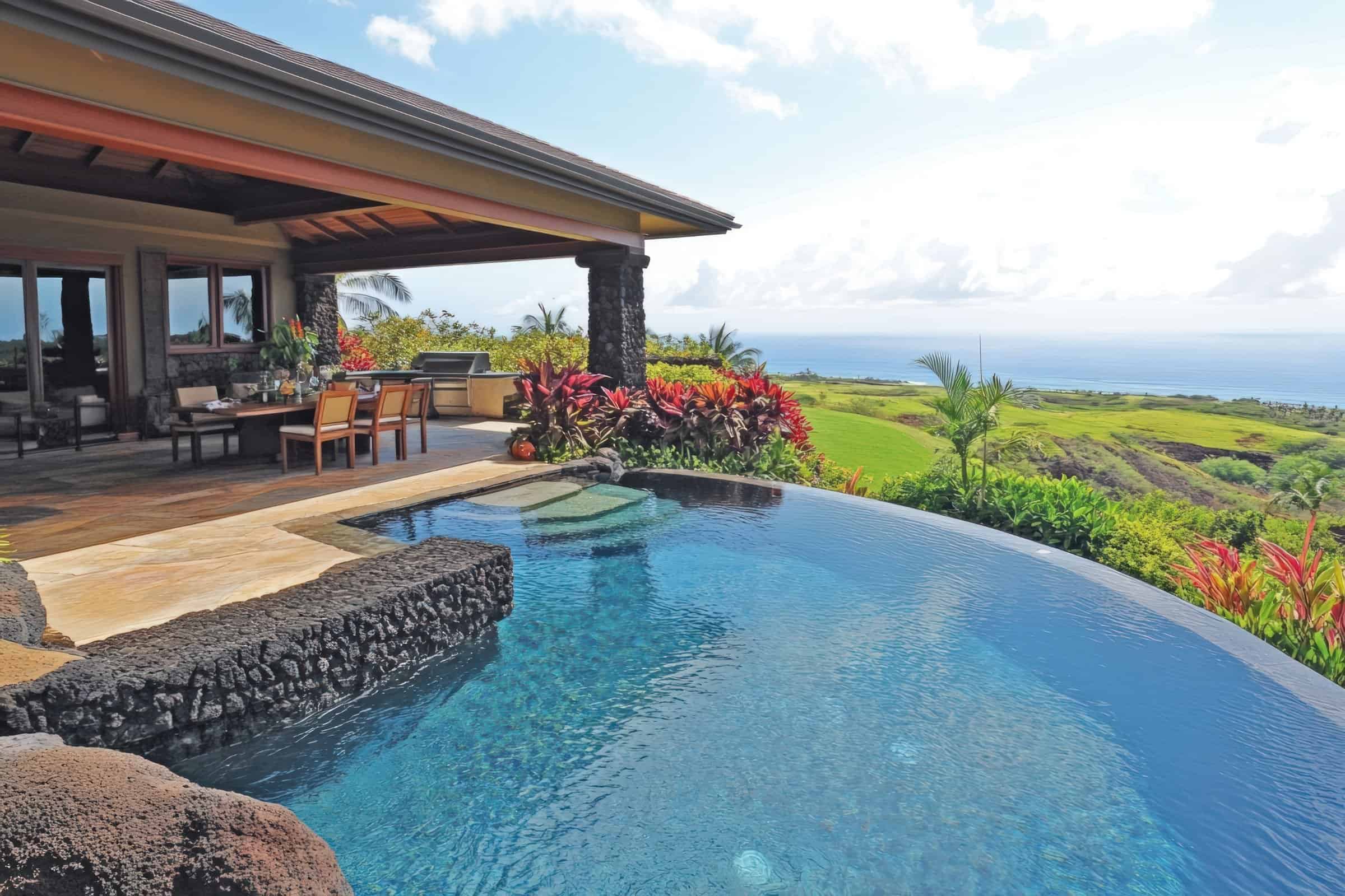 Luxury Big Island Hawaii real estate with oceanview infinity pool, tropical gardens, and Kona coast.