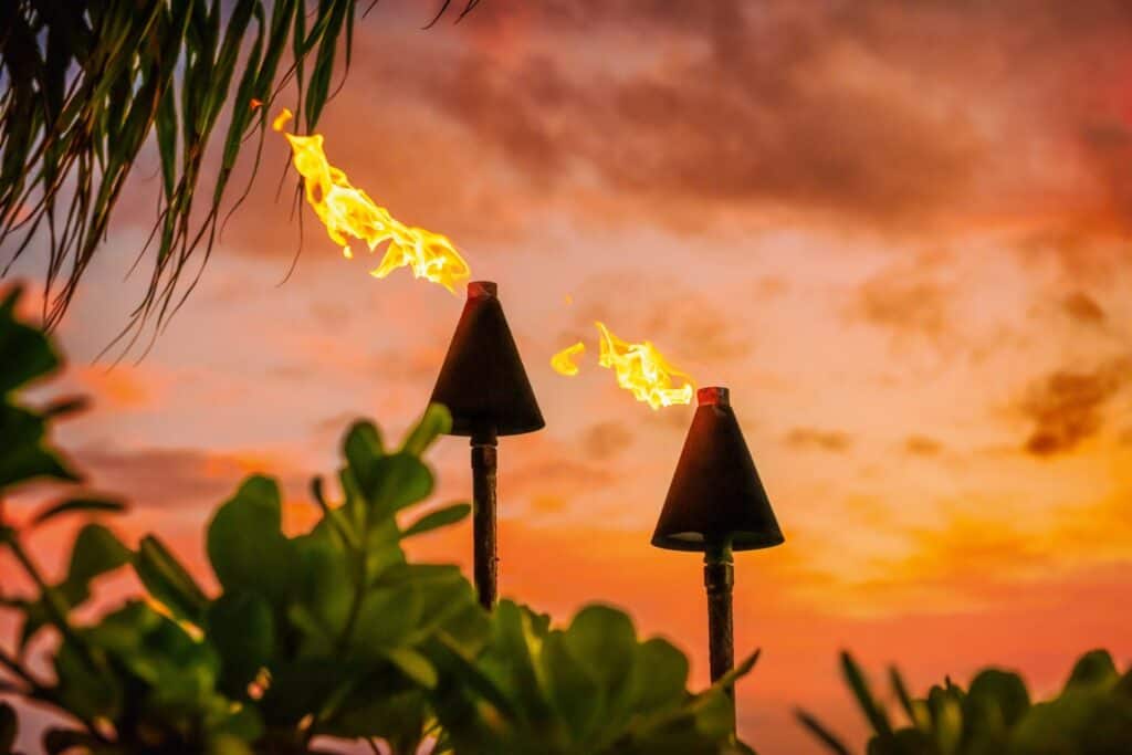 Tiki torches on Big Island Hawaii property, Kona coast, creating a tropical, luxurious outdoor ambia.