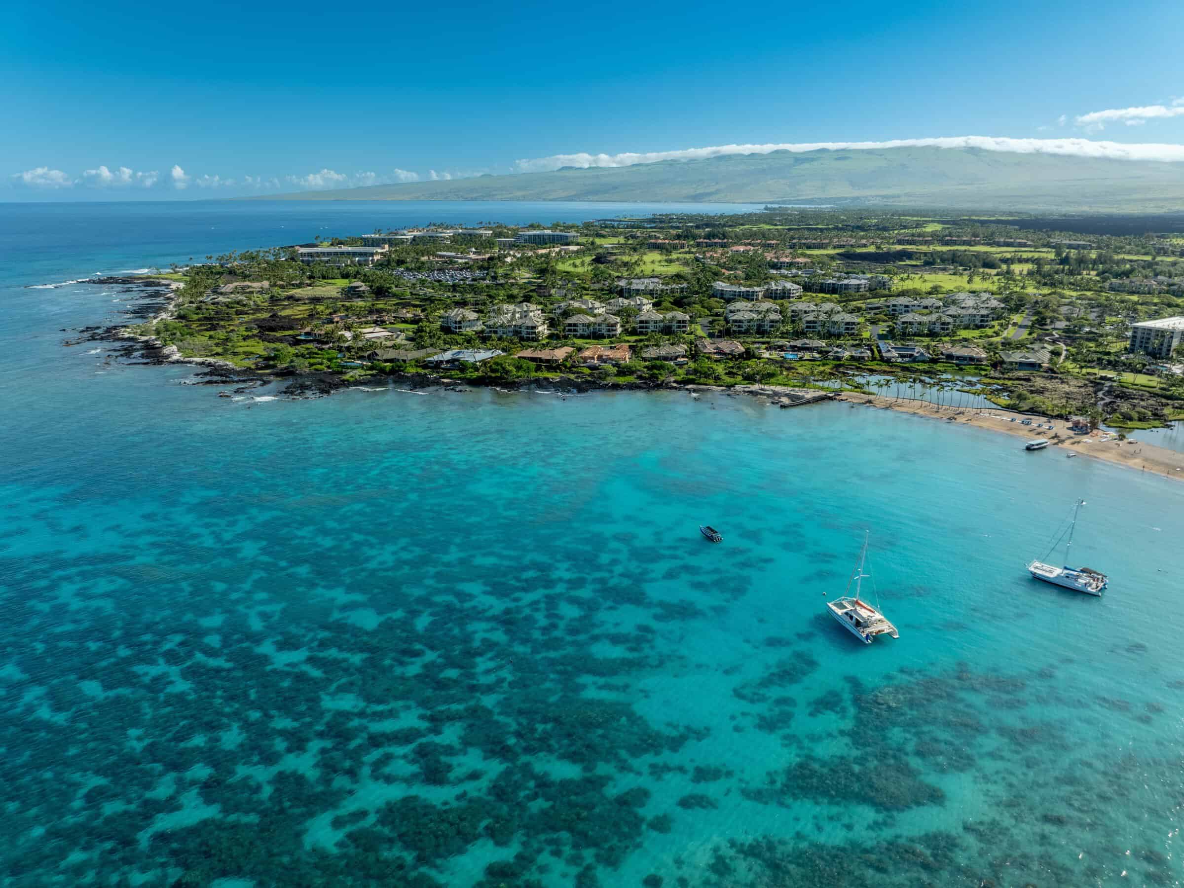 Aerial view of Big Island Hawaii showcasing luxury oceanfront properties, lush landscapes, and coast.