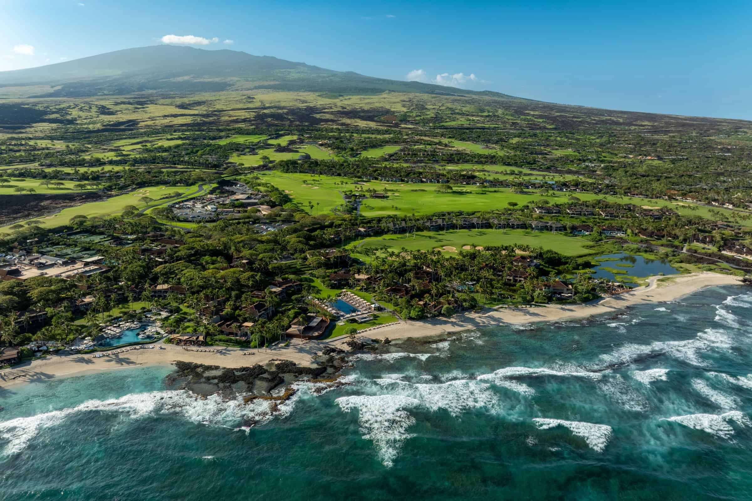 Aerial of Hualalai Resort, the golf course and homes along the North Kona coastline.