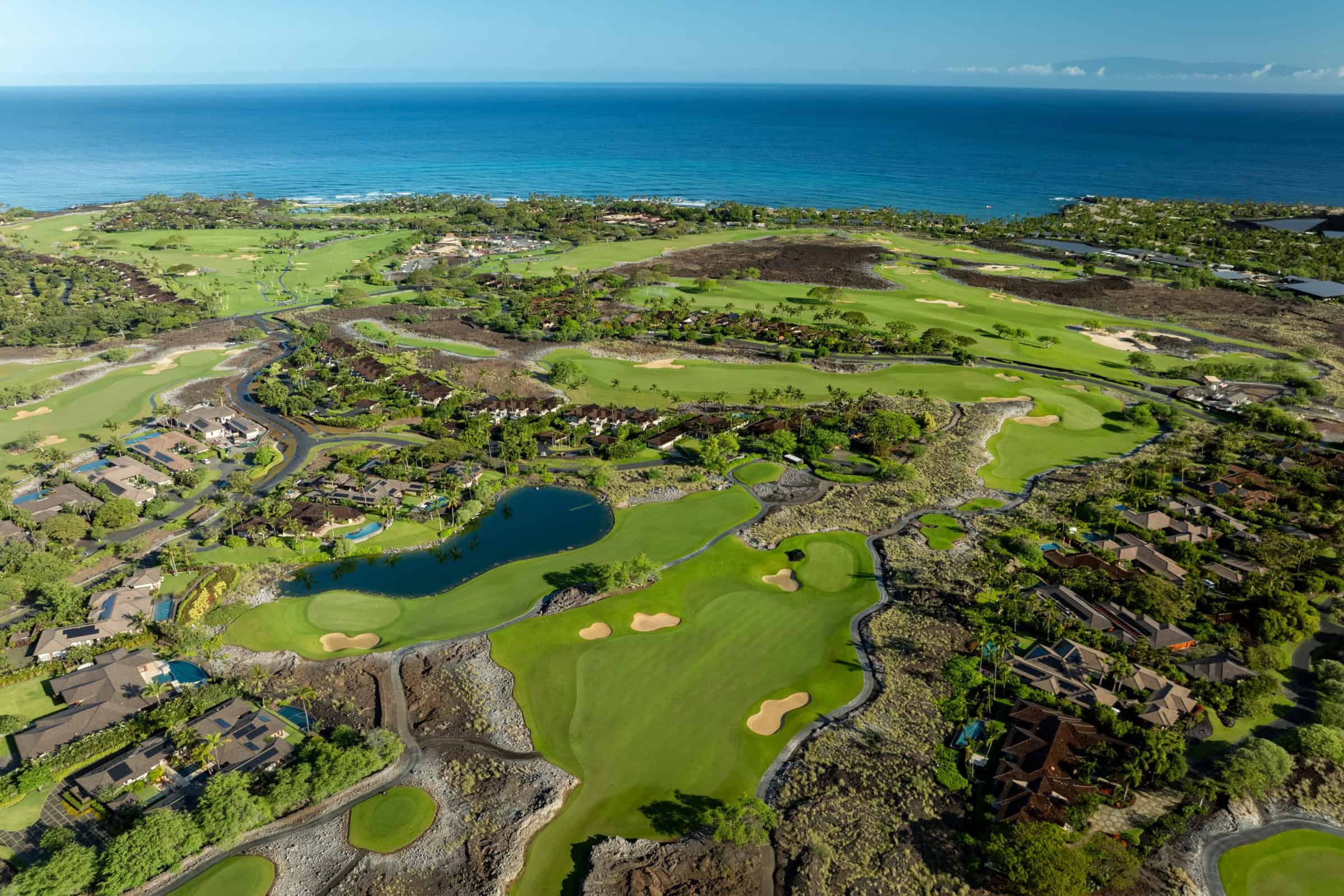 Aerial of the golf course and lake at Hualalai Resort on the North Kona coast.