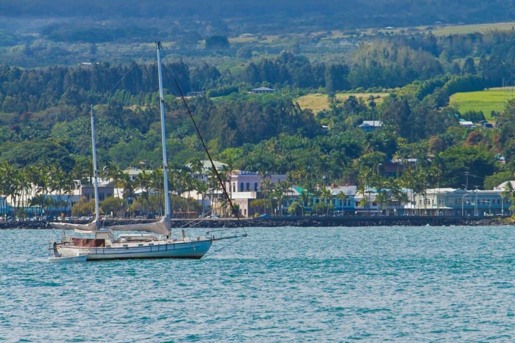 Oceanfront property in Hilo, Big Island Hawaii with boat dock and lush landscape.