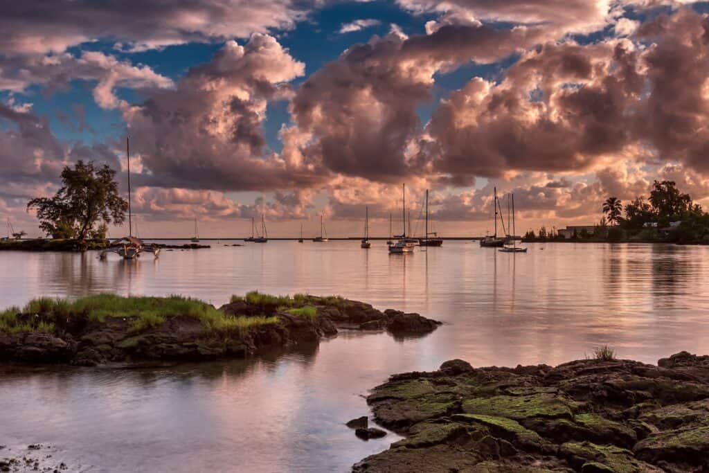 Big Island Hawaii oceanfront property with sailboats and sunset views in Hilo.