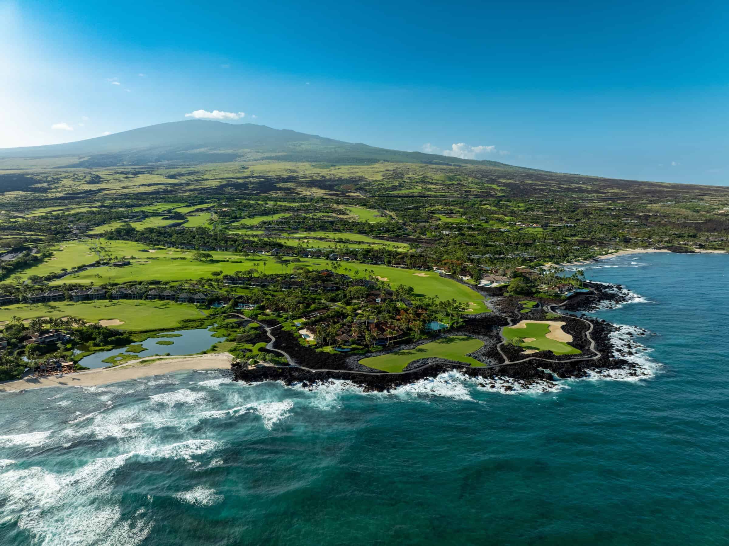 Luxury oceanfront estate in Hualalai Resort, Big Island Hawaii, with lush golf course views.