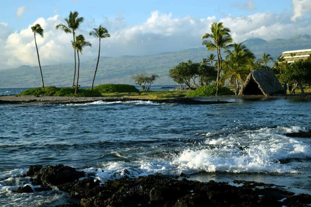 Luxury oceanfront estate in Kohala Coast with tropical landscaping and mountain views.