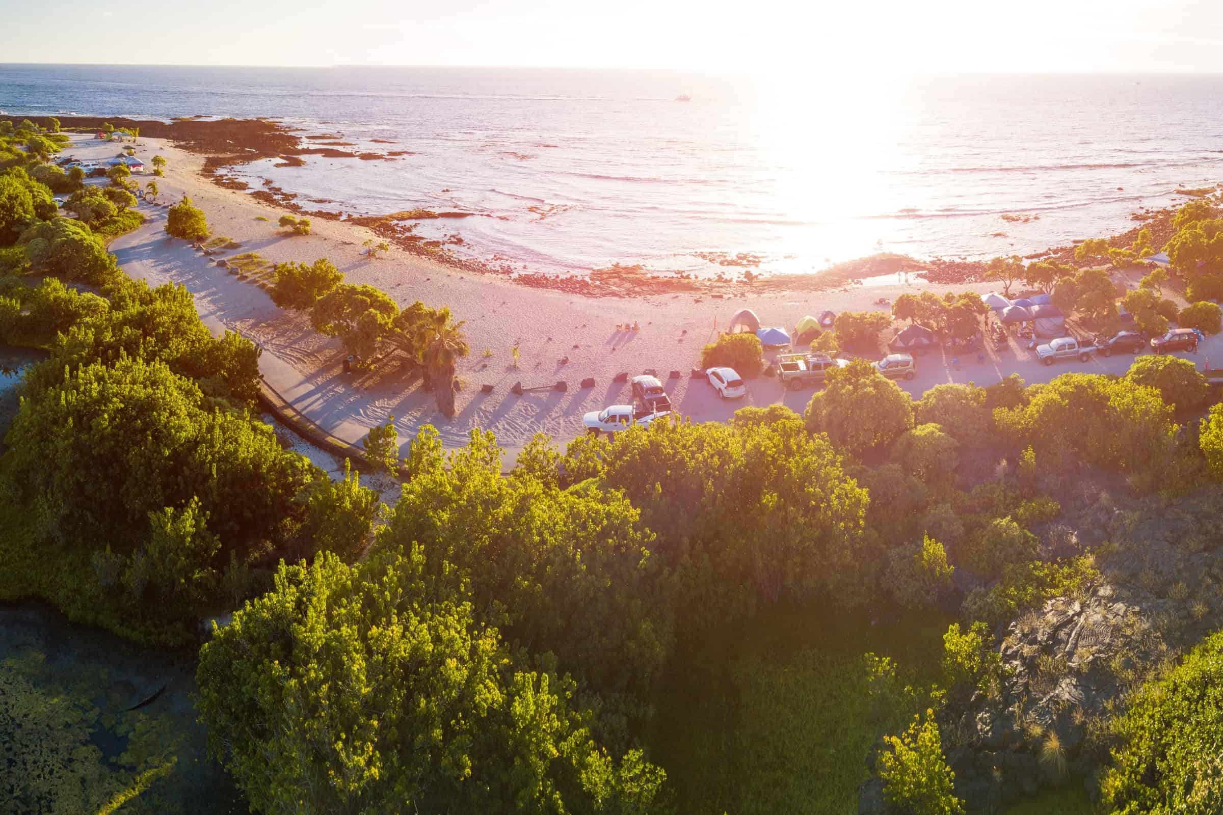 Luxury oceanfront condo in Kohala Coast with resort amenities and stunning sunset views.
