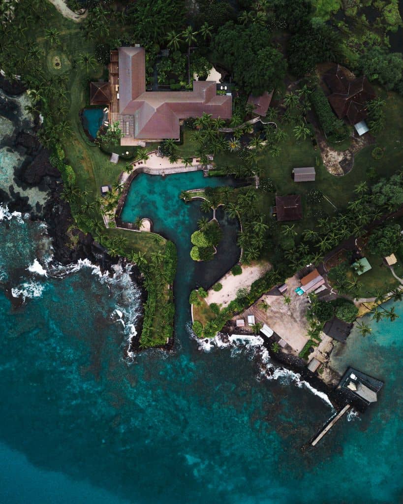 Aerial of an oceanfront estate set among anchialine ponds and lava rock on the North Kona coast.