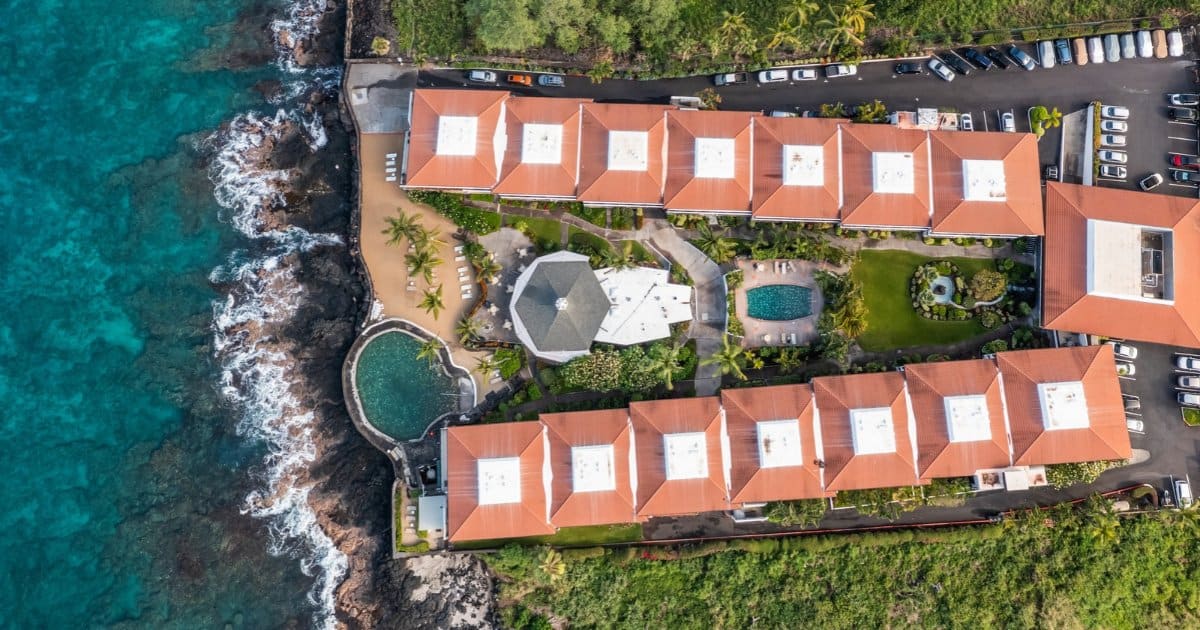 Aerial of an oceanfront condo complex on the lava coast, one of many Big Island condos