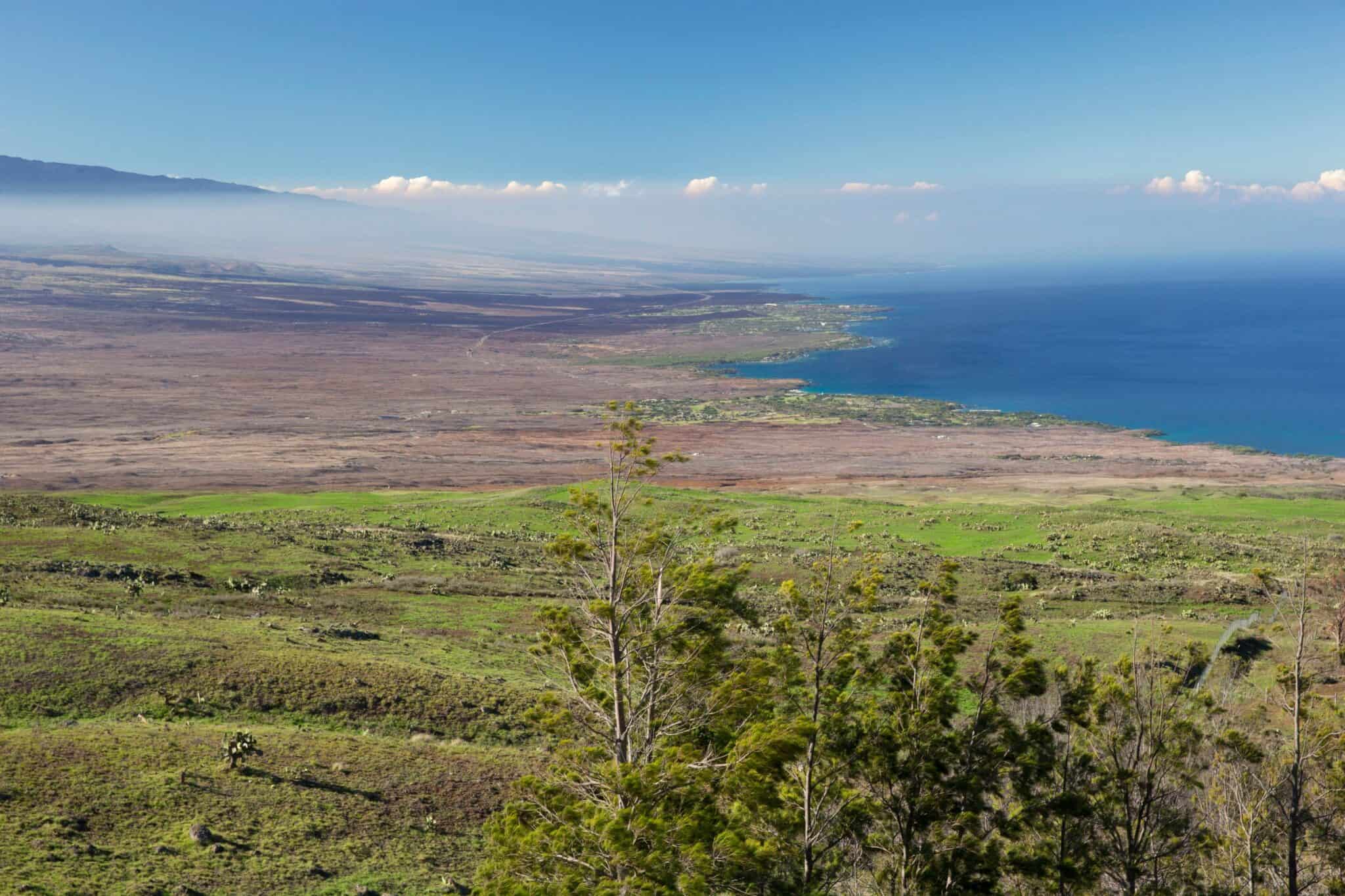 Oceanfront land in Kohala Coast with mountain views and lush landscape.