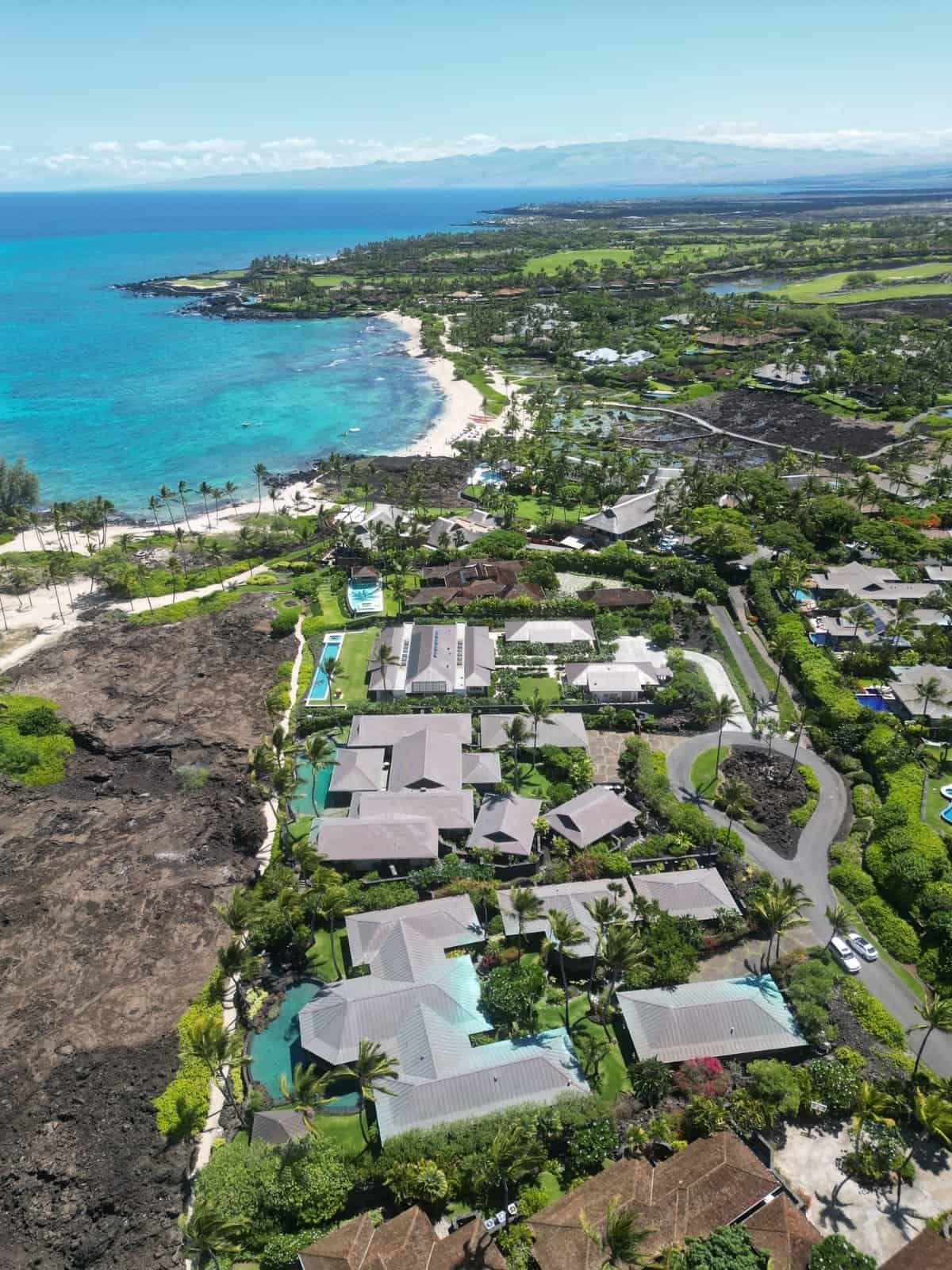 Aerial of the oceanfront homes and lava shoreline at Kukio on the North Kona coast.