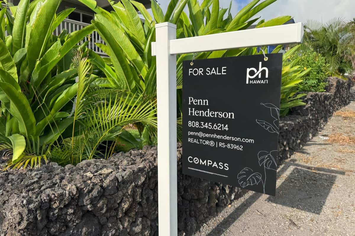 Penn Henderson, Compass REALTOR, at a listing sign in Kailua-Kona, Hawaii