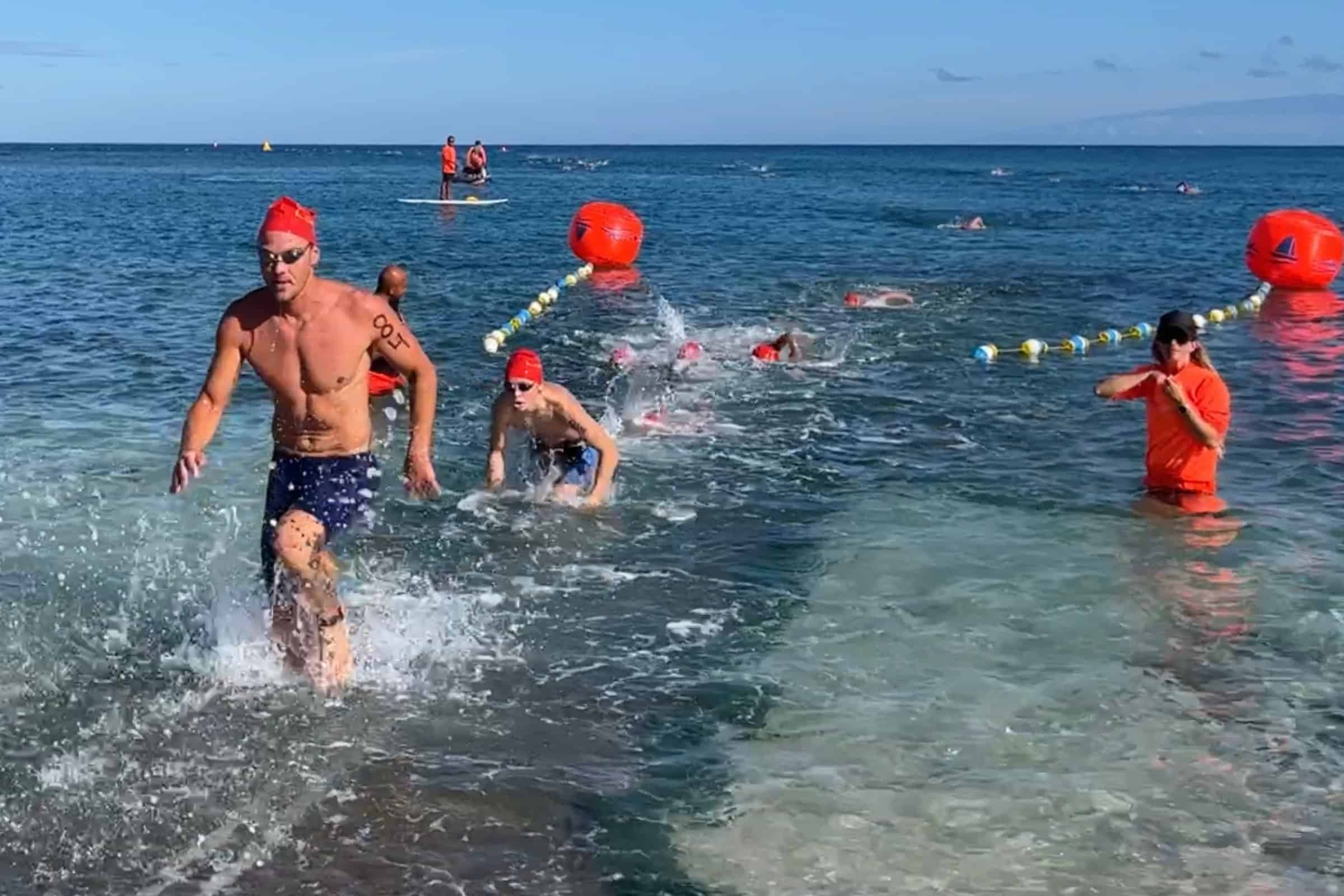 Swimmers heading out past the buoys at the start of the one mile race in A-Bay at Waikoloa Beach Resort.