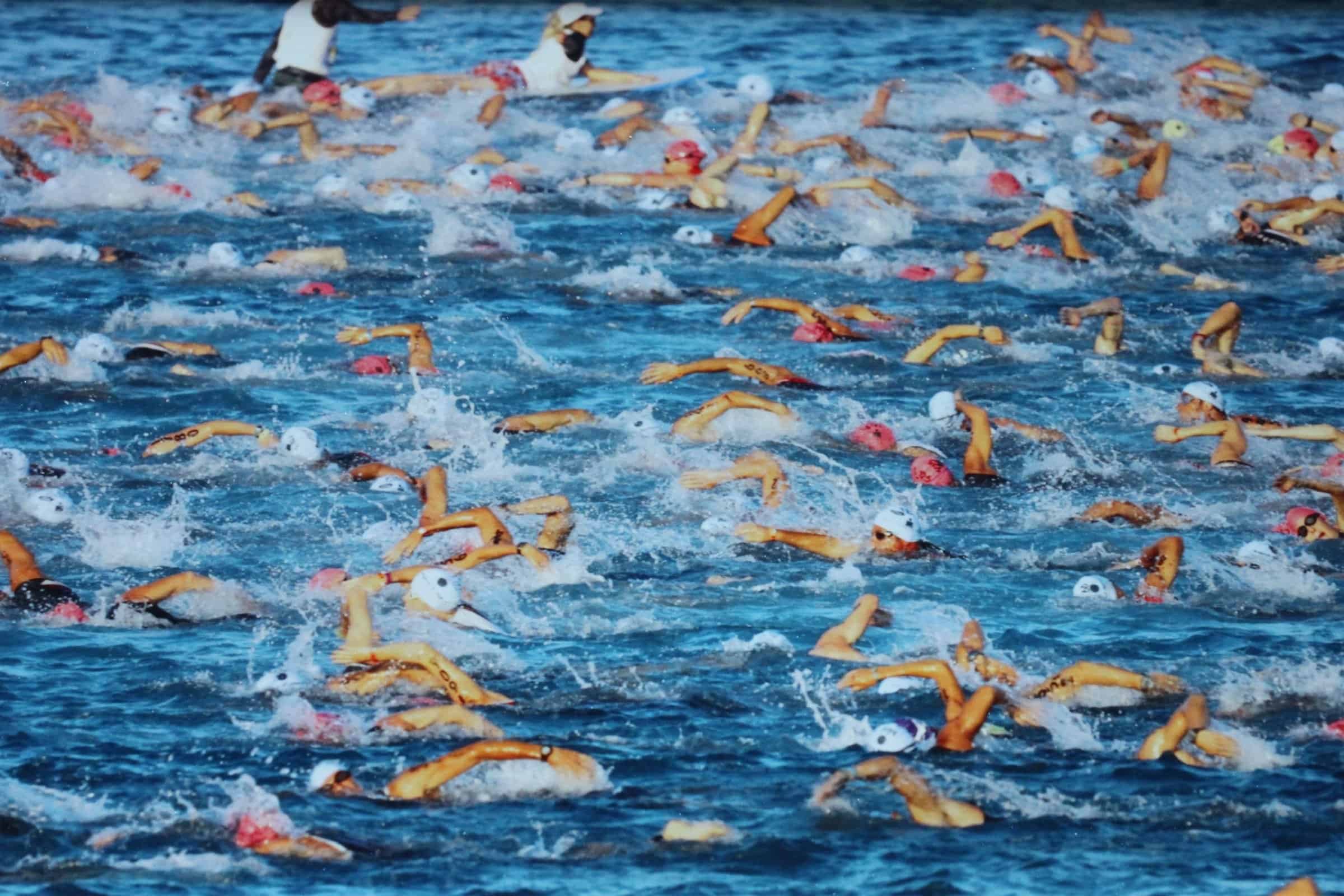 Overhead view of the mass swim start churning the water in Kailua Bay at the IRONMAN™ World Championship.