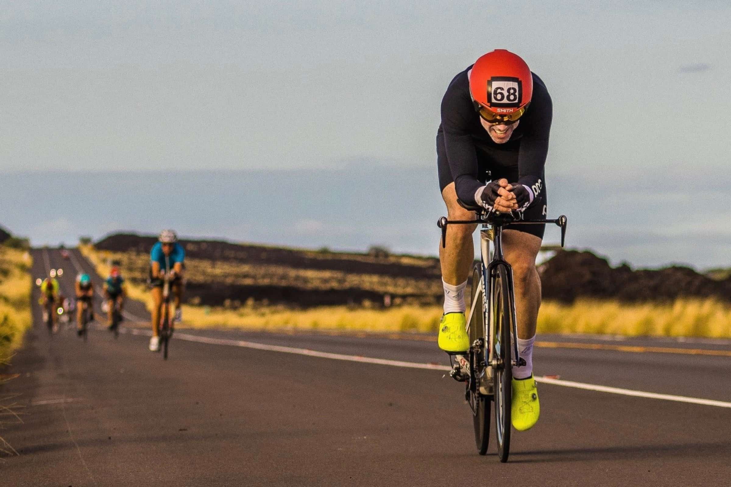 Cyclist tucked in aero position on the Queen Kaahumanu Highway during the Lavaman triathlon.